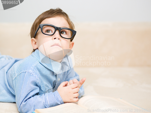 Image of Little boy is reading book