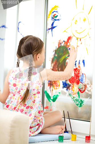 Image of Portrait of a cute girl playing with paints