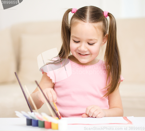 Image of Cute cheerful child play with paints