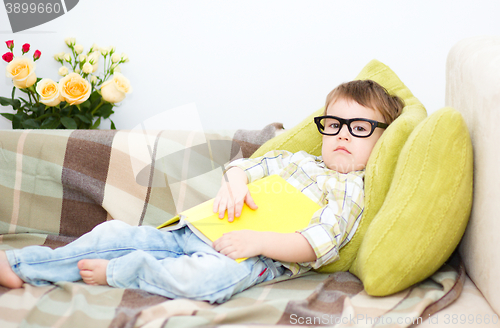 Image of Little boy is reading book