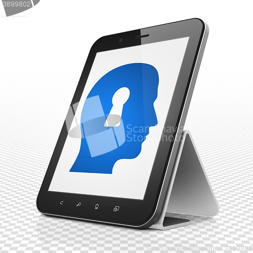 Image of Finance concept: Tablet Computer with Head With Keyhole on display