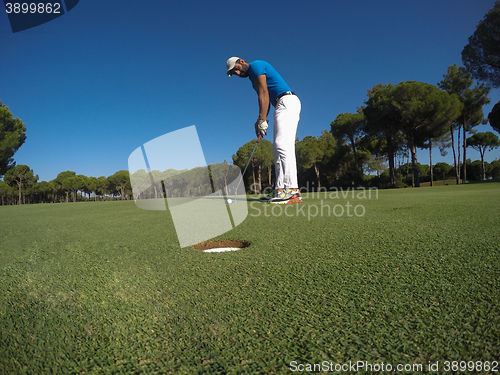 Image of golf player hitting shot at sunny day