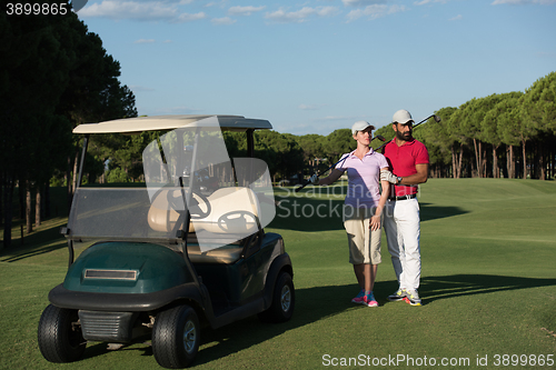 Image of couple in buggy on golf course