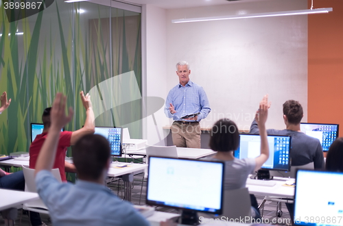 Image of teacher and students in computer lab classroom