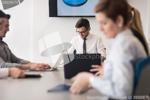 Image of young business people group on team meeting at modern office