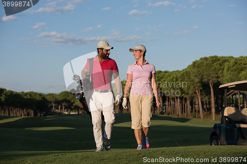 Image of couple walking on golf course