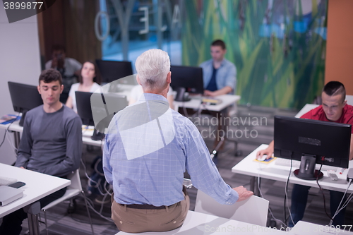 Image of teacher and students in computer lab classroom