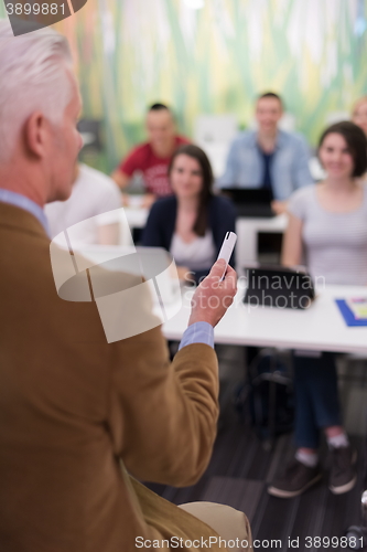 Image of teacher with a group of students in classroom