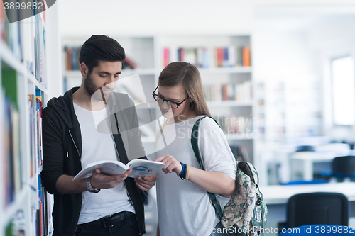 Image of students couple  in school  library