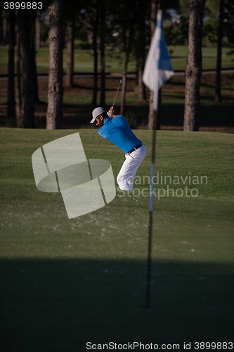 Image of pro golfer hitting a sand bunker shot