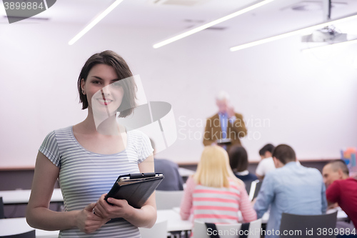 Image of portrait of happy female student in classroom