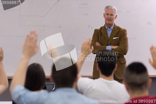 Image of teacher with a group of students in classroom