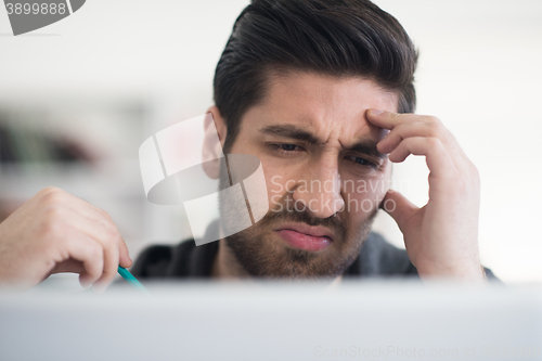 Image of student in school library using laptop for research