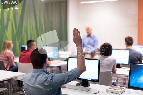 Image of student answering a question in classroom