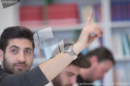 Image of group of students  raise hands up