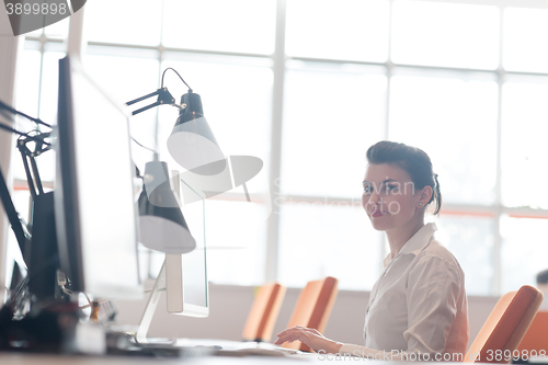 Image of business woman working on computer at office