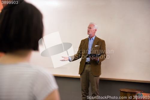 Image of teacher with a group of students in classroom