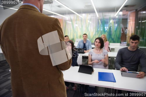 Image of teacher with a group of students in classroom