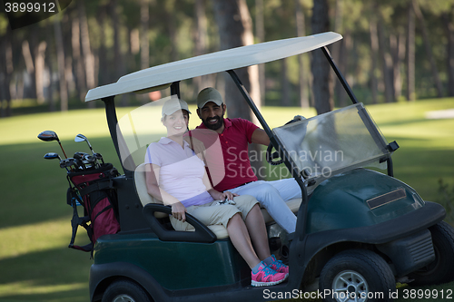 Image of couple in buggy on golf course