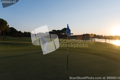 Image of golfer hitting ball to hole