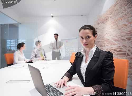 Image of young business woman on meeting  using laptop computer