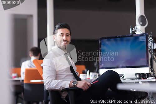 Image of young business man  working on desktop computer