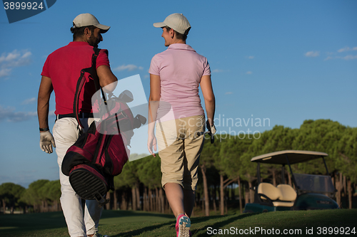 Image of couple walking on golf course