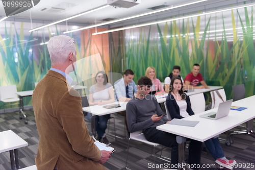Image of teacher with a group of students in classroom