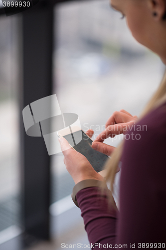 Image of business woman using smart phone at office