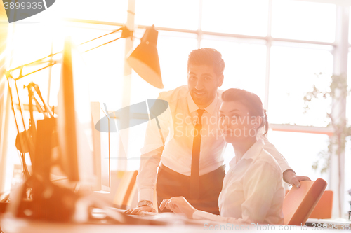 Image of business couple working together on project, sunrise in backgrou