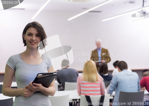 Image of portrait of happy female student in classroom