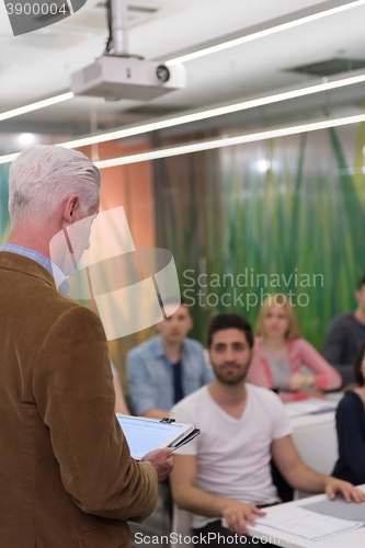 Image of teacher with a group of students in classroom