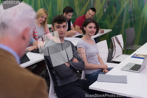 Image of teacher with a group of students in classroom