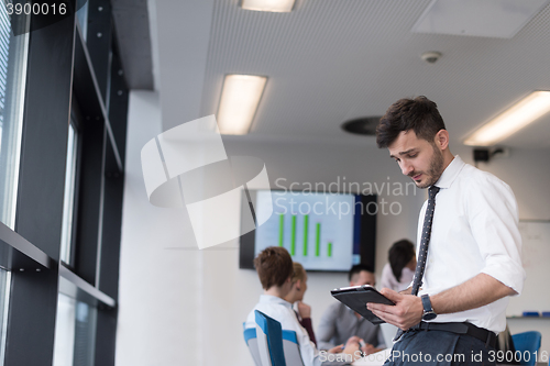 Image of young business man with tablet at office meeting room