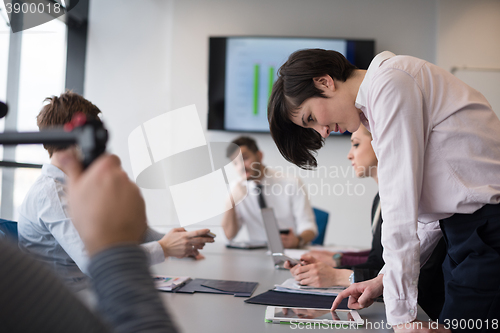 Image of young  woman using  tablet on business meeting