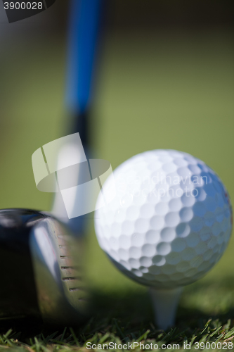 Image of golf club and ball in grass