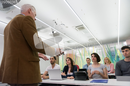 Image of teacher with a group of students in classroom