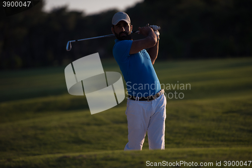 Image of golfer hitting a sand bunker shot on sunset