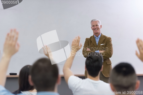 Image of teacher with a group of students in classroom