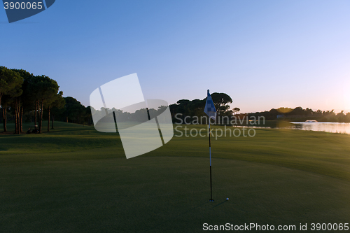 Image of golf ball on edge of  the hole