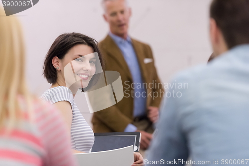 Image of teacher with a group of hi school students in classroom