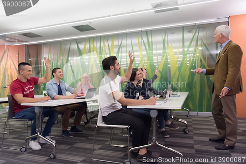 Image of teacher with a group of students in classroom