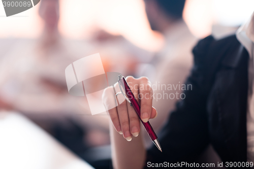 Image of woman hands holding pen on business meeting