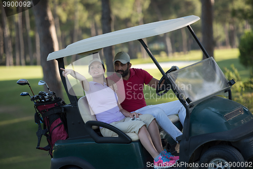 Image of couple in buggy on golf course