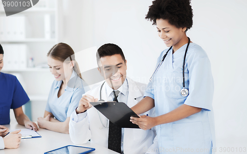 Image of group of happy doctors meeting at hospital office