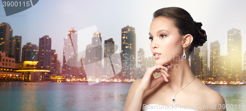 Image of beautiful asian woman with earring and pendant