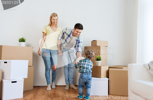 Image of happy family moving to new home and playing ball