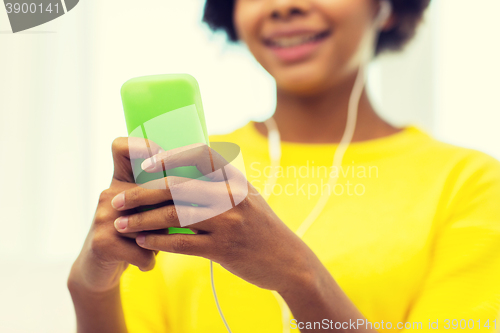 Image of happy african woman with smartphone and headphones