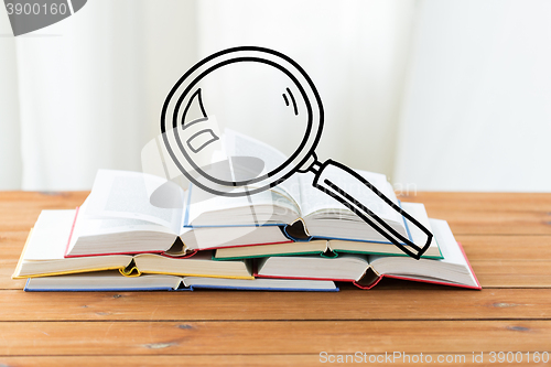 Image of close up of books on table with loupe doodle