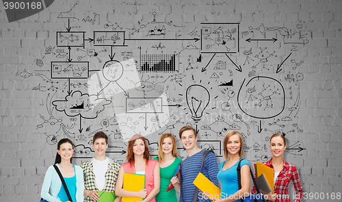 Image of group of teenage students with folders and bags